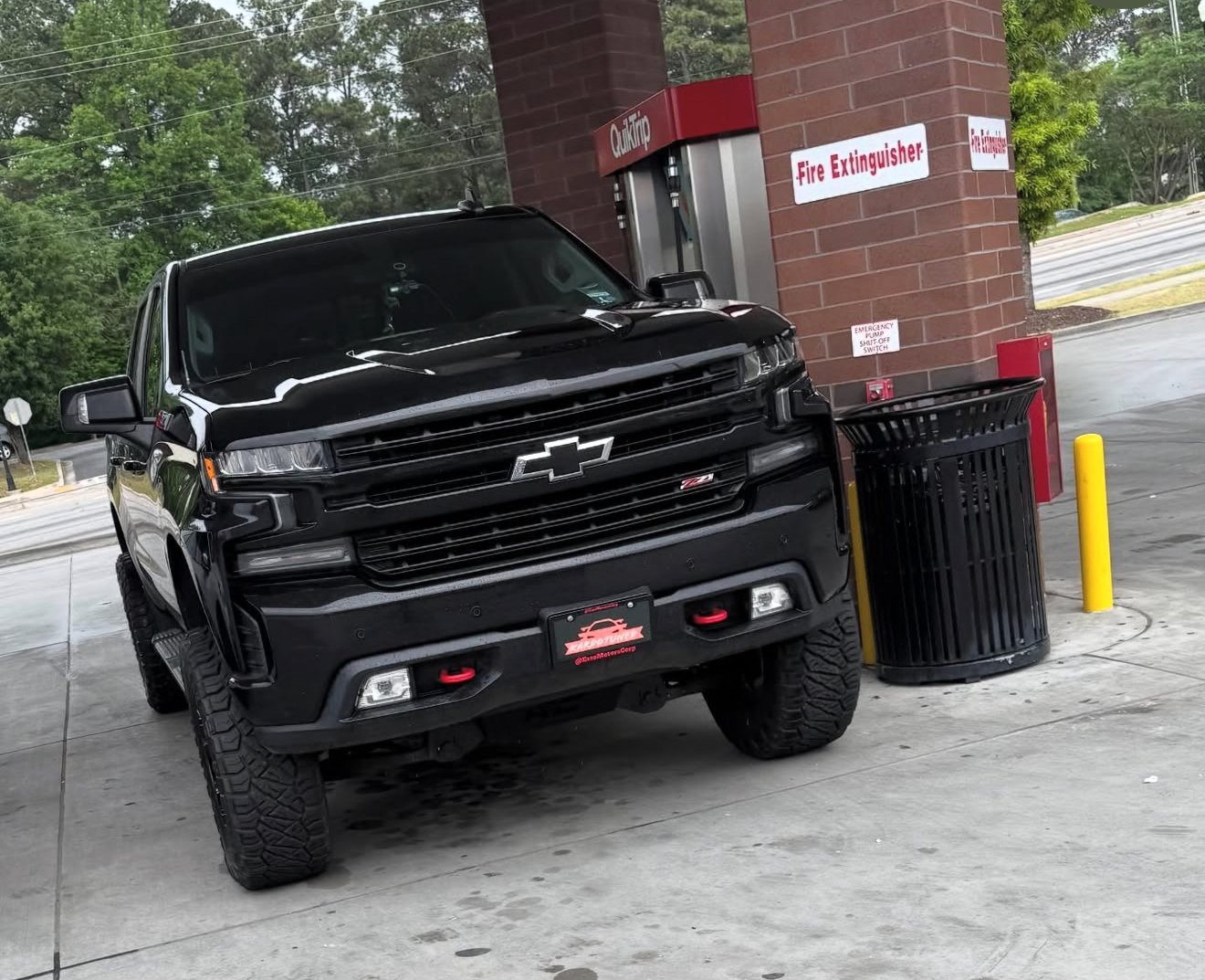 Black Chevrolet pickup truck parked on concrete lot